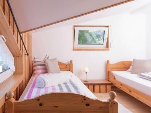 a bedroom with two beds and a table at Homey Chalet in Breitenbrunn Rittersgrun in Breitenbrunn