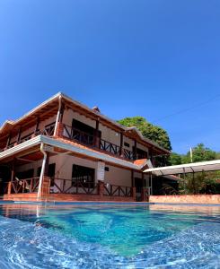 a resort with a swimming pool in front of a building at Casa Campestre Las Nieves in San Gil