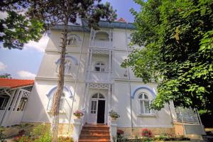 a white house with a staircase in front of it at Vila Brancoveanu in Eforie Sud