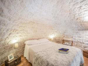 アルベロベッロにあるCozy Cottage in Alberobello with Private Gardenのベッドルーム1室(ベッド1台、本付)