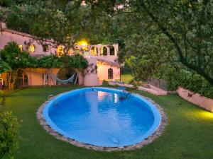 a large blue pool in the yard of a house at Belvilla by OYO Limoni in Ricadi