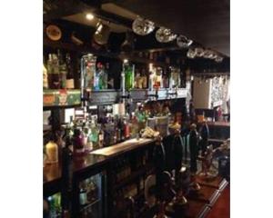 a bar filled with lots of bottles of alcohol at Seven Stars in Dartmouth