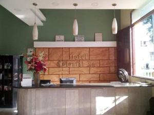 a restaurant with a counter with flowers on it at Hotel Colonial Inn in Barranquilla
