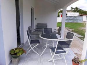 a patio with a table and chairs on a porch at Maison de 2 chambres avec jardin clos a Grand Bourg in Grand-Bourg