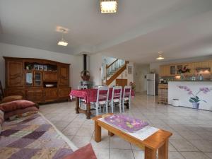 a living room with a table and a kitchen at Tasteful holiday home in Plouvara with garden in Saint-Donan