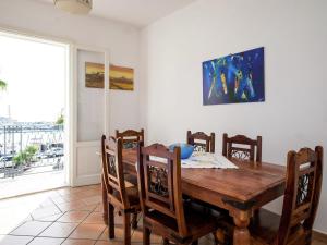 a dining room with a wooden table and chairs at Pleasant Holiday Home in Santa Flavia in Santa Flavia