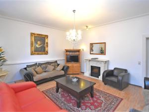 a living room with a couch and a table at Heritage villa with home cinema sauna in Treuen