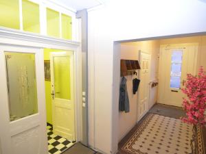a hallway with yellow doors and a checkered floor at Heritage villa with home cinema sauna in Treuen
