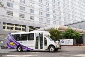 a purple and white bus parked in front of a building at Hyatt Regency Los Angeles International Airport in Los Angeles