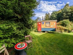 a tiny house in a yard with a table and chairs at Holiday Home in Houffalize With Terrace in Houffalize