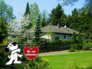 a sign with a mickey mouse holding a heart at Cosy Apartment in Diemelsee with Fenced Garden in Diemelsee