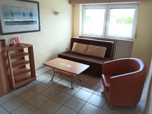 ÜxheimにあるApartment in Leudersdorf Eifel with terraceのリビングルーム(ソファ、椅子、テーブル付)
