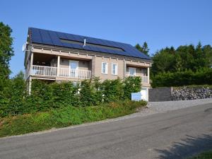 a house with solar panels on the roof at Sumptuous Chalet in Septon with Sauna bubblebath in Septon