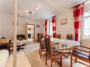 a living room with a dining room table and chairs at Comfortable Apartment in Ediger Eller Eifel in Sankt Aldegund