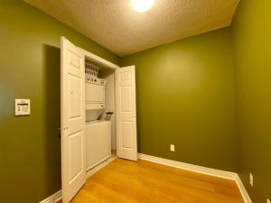 an empty room with green walls and a white door at Executive Furnished Properties - Mississauga in Mississauga