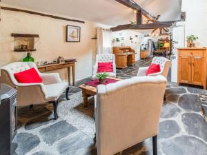 a living room with chairs and a table at Characteristic holiday home in Cherain with balcony in Cherain