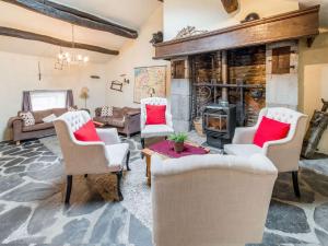 a living room with chairs and a wood stove at Characteristic holiday home in Cherain with balcony in Cherain