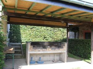 a barbecue under a wooden pergola at Quiet location terrace ideal for walks cycling in Waimes