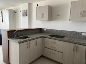 a kitchen with a sink and a counter top at Ocean Club - Ocean Suites II in Playas