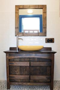 a bathroom sink with a mirror on a wooden dresser at Gypsy Hill in Ortaca