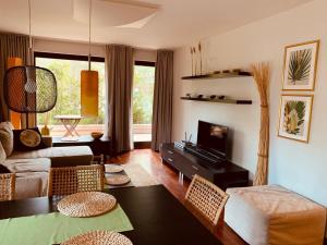 a living room with a couch and a tv at Apartament Bornholm in Jurata