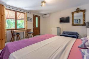 a bedroom with a large bed and a desk at Crikvenica Apartment 89 in Dramalj