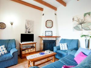 a living room with two blue couches and a fireplace at Belvilla by OYO Villa Campanet Vell in Campanet
