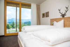 Postel nebo postele na pokoji v ubytování Hotel Die Alm