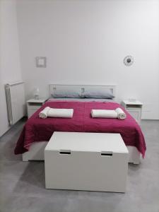 een witte slaapkamer met een bed en twee nachtkastjes bij Darsena Apartments1 in Molfetta