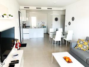 a living room with a couch and a table at Sol Blanco in Arenales del Sol