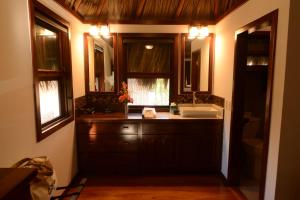 a bathroom with a sink and a mirror at El Ben Cabañas in Caye Caulker +66 photos