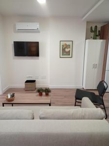 a living room with two couches and a tv at First Row Sea Estepona in Estepona