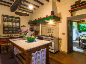 a kitchen with an island with a bowl of fruit on it at Belvilla by OYO l Antica Casa in San Marcello Pistoiese