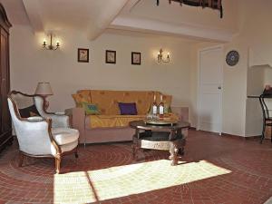 a living room with a couch and a table at Sunny house in Fayence with terrace in Fayence