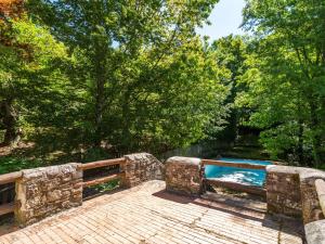 a swimming pool in the middle of a forest at Spacious Holiday Home with shared pool in San Marcello Pistoiese