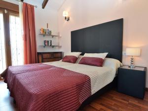 a bedroom with a large bed with a large black headboard at Belvilla by OYO Villa Orange in Algorfa