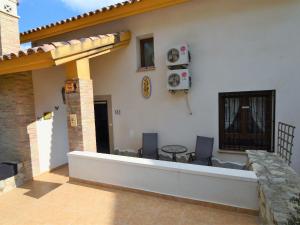 a patio with a table and chairs on a house at Belvilla by OYO Villa Orange in Algorfa
