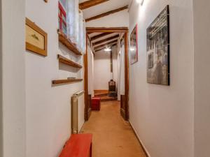 a hallway with a red bench and paintings on the walls at Belvilla by OYO Loggetta in San Marcello Pistoiese
