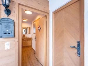 a wooden door in a room with a hallway at Modern Chalet with Sauna in Niedernsill in Niedernsill