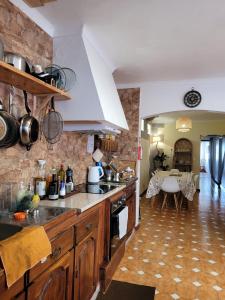 a kitchen with wooden cabinets and a counter top at The Handmade House Azores in Porto Formoso
