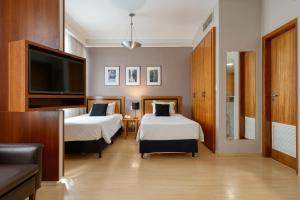 Cama ou camas em um quarto em Mercure Belo Horizonte Savassi