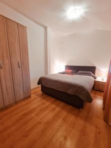 a bedroom with a bed and a wooden floor at Village experience - Skadar lake in Virpazar