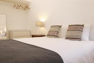 1 dormitorio con 1 cama blanca y 2 almohadas en CASA AZUL, en Monchite