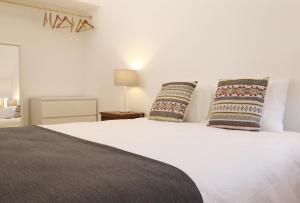 a bedroom with a white bed with two pillows at CASA AZUL in Monchite