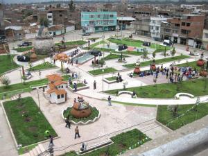 a group of people walking around a plaza in a city at Hostal Sauna Tambo Wasi in Huancayo