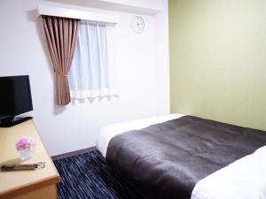 Postel nebo postele na pokoji v ubytování Nagoya Sakae Green Hotel