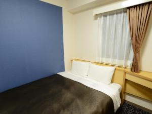Postel nebo postele na pokoji v ubytování Nagoya Sakae Green Hotel