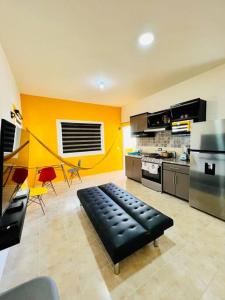 a kitchen with a black bench in the middle of a room at El mirador de Los Sauces in Puerto Vallarta