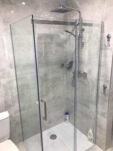 a shower with a glass door in a bathroom at Apartament Nowodworska in Elblag