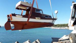 a boat that is sitting in the water at Vila Melisa in Vrgada